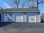 Free Standing 3 Car Garage with two Garage Doors and 1 other ingress/egress door surrounded by additional Parking. Suitable for a Builder/Landscaper or for Car Storage.