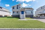Enjoy unparalleled panoramic views of Shinnecock Bay in this meticulously kept waterfront home. Inside, the 5-bed 3.5-bath updated home has a vaulted-ceiling great room, a separate breakfast area overlooking the bay, and an open-style chef&rsquo;s kitchen with a breakfast bar. Two bedrooms are located on the first floor; three bedrooms and a separate den are located upstairs. Large windows and glass doors flood the home with natural light in all directions, and its close proximity to the water evokes a sense of being on a boat. Outside, the first and second-floor decks overlook the water along 75&rsquo; of bulkheaded shoreline. The house was lifted to a raised foundation in 2017 to protect against high-water risks. Shinnecock Shores is a charming neighborhood with a private bay beach a few doors down the street, boat slips, and playground. An ideal summer and year-round escape.