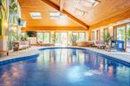 Welcome to this stunning contemporary masterpiece, featuring a resort-style indoor pool and exquisitely designed spaces to suit every lifestyle. Offering over 6, 000 square feet of beautifully finished living space, designed for those who appreciate modern style, open spaces, and effortless entertaining. Set on a private, tranquil property, yet just minutes from the vibrant Eastdale Village, this home perfectly balances seclusion with convenience, all less than 1.5 hours from Manhattan. Thoughtfully renovated from top to bottom, every inch of this home reflects refined design and quality craftsmanship. Upon entering, youâ€™re welcomed by the tastefully designed foyer and sun-drenched interiors, with an open-concept living room anchored by a sleek gas fireplace. The seamless connection to the outdoor space floods the room with natural light. The spacious chefâ€™s kitchen is equally impressive, featuring stainless steel appliances, custom finishes, and ample workspace, making it the heart of the home for both casual mornings and lively gatherings. The primary suite is a retreat unto itself, offering a luxurious en suite bathroom, a private sunroom, and an outdoor porchâ€”the perfect place to begin or end your day. The homeâ€™s additional tastefully renovated bathrooms continue the theme of modern elegance, ensuring both style and comfort throughout. At the center of this homeâ€™s lifestyle experience is its indoor pool, complete with a hot tub and custom bar, transforming everyday living into a resort-inspired escapeâ€”whether entertaining guests or enjoying quiet relaxation. A wraparound porch invites you to unwind outdoors and take in the serenity of the propertyâ€™s natural setting. With central air conditioning, a two-car garage, and ample privacy, this home offers a turn-key modern living experience. Yet, it is ideally located just under five miles from Eastdale Villageâ€™s dining and shops, and moments from the Taconic State Parkway, Poughkeepsie Metro-North, and the charming towns of Millbrook and Rhinebeck. Combining sleek contemporary design with the ease of Hudson Valley living, this one-of-a-kind home is ready to welcome youâ€”schedule your private viewing today.