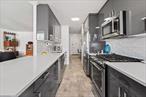 MOTIVATED SELLER! Welcome home to this beautifully renovated 5th floor apartment at Park Lane South. The K line is one of the largest lines in the building, offering a great layout with generous entry foyer. Spacious dual closets greet you along with a flex space showcasing a home office. The kitchen was extended into a modern layout with island for entertaining. No detail was left undone. Sleek, modern cabinetry paired with top of the line appliances, stain-proof, quartz counters and soft-close drawers and doors will bring any home chef to their happy place. The living/dining combo is smart and functional with enough room for everything. A comfortable terrace provides that coveted outdoor space to call your own. Down the hall is a custom hall bath with tub, lovely porcelain tile & top-of-the-line fixtures. Across the hall is the first bedroom, showcasing a comfortable den. At the end of the hall is the king-size primary bedroom with ensuite bathroom with shower and wall of closets at the entry. The bathroom shower has a rainforest showerhead and all the bells and whistles making it feel more hotel-like at home.ALL UTILITIES ARE INCLUDED in the maintenance. Post-war, concrete, fireproof building ensures quiet serenity - you do not hear sounds from next door, above or below. The building boasts a lovely foyer entry and waiting area with 24-hour doorman. Building Link informs you about deliveries. Other amenities include common laundry and bike storage. Cats are welcome. No dogs. Improvements include common hallways renovation with new wall treatments, carpets and apartment doors painted. Local Law 11 work recently completed. The location is unbeatable. Around the corner from E & F trains. Equidistant from Kew Gardens and Forest Hills LIRR stops. Blocks from Q10 Bus which connects to JFK airtrain. Close to all restaurants and convenient commerce in both Kew Gardens and Forest Hills, houses of worship, City parks and across the road from Forest Hills Gardens, home to both the West Side Tennis Club and Forest Hills Stadium.