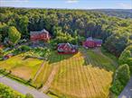 Welcome to 987 Hurd Road, a picturesque 4-bedroom, 3-bath tri-level farmhouse in the heart of Sullivan County. Nestled on 1.15 acres, this 2, 350 sq. ft. home blends modern comforts with timeless charm. Step inside to an inviting open-concept layout, featuring hardwood floors, two fireplaces, and a sun-filled living area perfect for cozy nights in. The kitchen boasts stainless steel appliances, ample cabinetry, and a wet bar, making it an entertainerâ€™s dream. The primary suite includes a soaking tub and walk-in closet, offering a private retreat. Outdoor enthusiasts will love the deck, patio, and porch, all showcasing breathtaking mountain views. With a one-car garage, central air, and septic and well water, this home is move-in ready. Located in the Sullivan West School District, itâ€™s minutes from Bethel Woods, lakes, and hiking trailsâ€”perfect for those seeking a peaceful escape or a year-round residence.