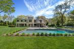 Discover the epitome of luxury living in East Hampton South. This exceptional residence, designed by the renowned Robert A. M. Stern Architects and Bates Masi Architects, is set on a stunning 1.24+/- acre lot meticulously landscaped with specimen plantings throughout. The expansive, gated grounds create a serene setting complemented by a pool and spa, while the iconic modern home stands as a testament to architectural brilliance. The main residence offers 5, 300+/- square feet of meticulously crafted living space, featuring 5 bedrooms, a bonus room, and 6.5 bathrooms. Each bedroom is a sanctuary of comfort, with the primary suite offering a private office, a walk-in closet, an en-suite bath with a soaking tub and dual sinks, and a large balcony deck, overlooking the backyard. The additional bedrooms are equally luxurious, all featuring access to a second-level deck. The interior spaces are designed for both relaxation and entertainment. The family room, office, and media room provide ample space for work and leisure, while the finished lower level adds an extra layer of versatility. The home is adorned with top-of-the-line finishes throughout, ensuring every corner exudes elegance and sophistication. High ceilings, large windows, and an open floor plan create a bright and airy atmosphere, enhancing the sense of space and luxury. The exterior of the property is equally impressive. The estate includes a heated gunite pool, perfect for a refreshing dip on a warm summer day, set amidst beautifully landscaped grounds with plenty of space for outdoor activities and entertaining. Expansive patios and outdoor living areas provide the perfect backdrop for al fresco dining and gatherings. Nestled in the heart of East Hampton, the property is just a mile from beautiful beaches and luxury transportation options, making it an ideal location for those seeking both privacy and convenience. This is the only modern Robert A.M. Stern design in the Hamptons, making it a true architectural gem. Whether you seek privacy, versatility, or the ultimate in luxury, 151 Skimhampton Road is your perfect sanctuary in the East Hampton South.