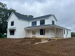 Brand New Construction to be completed Fall of 2025. This is a 3, 135 sqft Farm house style home with a wrap around porch, board and batten siding, 30 year architectural roof and black exterior 400 series Anderson windows. The homes interior will feature a 2 story entry hall, a Great Room with soaring ceilings and a gas Fireplace, a Formal Dining Room, a spacious eat in kitchen with 42 upper cabinets, center island with microwave draw, stainless steel appliances, walk-in pantry and quartz countertops. There is a 1st floor laundry room with washer dryer. The 1st floor Primary bedroom will have 2 walk-in closets, a primary bath with 2 sinks, walk-in shower and free standing tub. The 1st floor and stairs will have oak floors throughout. Upstairs you have 4 bedrooms and another full bathroom. This home is to be built with a full basement, a 2 car garage, gas heating, central air conditioning, a small rear covered porch and an asphalt driveway. Design your own home as many options and upgrades still available to buyers at this time. Upgrades could include wood flooring on 2nd floor, Stove size, color of walls, tile to be used and many more!