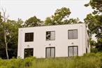 The Nine- Square house is, at its core, an authentic country house. The home is minimalist in structure so that it may support an inevitably maximal lifestyle - an extensive art collection & distinctive furnishings thrive in this home alongside an overflowing painting studio, outdoor gear for exploring the surrounding nature.Every feature of the home was conceived to be both functional & pleasing to the eye; after all, the team behind the house spent more than 2 years planning a design that addressed every conceivable ergonomic & environmental question. The nine-square philosophy of living, developed in the mid-1900s by the incredible architect & professor John Hejduk, is very much felt in the home&rsquo;s distribution & flow of spaces.On the ground floor are the double living room, dining area, & kitchen, all flowing into each other & anchored by a marble fireplace & 3 large glass doors opening to the exterior terrace with a breathtaking view. The kitchen features Danish-designed Reform cabinetry, Bardiglio marble, & Fisher Paykel appliances. An office/painting studio, a washroom, a dry bar, & laundry room complete the main level.The central architectural piece of the home is the solid white oak staircase leading up to the second floor. The 4 bedrooms upstairs, though spacious, are much more private & intimate, each with large windows on 2 sides, communing with the serene & quiet landscape outside, and sharing 2 sizable bathrooms.Distinguishing features of the Nine-Square House include high energy efficiency due to insulation exceeding all current standards, multi-zone central AC, radiant heated floors, solid 200 lb interior doors, satin nickel Kohler fixtures, cast iron sinks, & solid forged & machined brass & satin nickel door hardware.The 9 acres of land around the house, perfect as it is, has been touched as little as possible. There are wooded & open areas, with meandering walking paths trailing through the property.The Nine-Square House is just 20 minutes from Hudson, Great Barrington, & Millerton & 2 hours from New York City. The home is just a few minutes from Copake Lake.