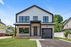 Move-In Ready! Discover this new construction home in desirable North Syosset, offering over 3, 400 square feet of thoughtfully designed living space. Featuring 5 bedrooms and 4.5 bathrooms, this home boasts a grand two-story entryway, 9-foot ceilings, and hardwood floors throughout. A second-floor laundry room adds convenience to everyday living. The first floor includes a versatile bedroom or home office with a full bath. The open-concept designer kitchen is equipped with premium appliances, a center island, and seamlessly flows into the great room with a gas fireplace. Upstairs, the spacious primary suite offers an oversized walk-in closet and a spa-inspired bath. Additionally, there are two bedrooms with a shared bath, plus a fourth bedroom with its own full bath and walk-in closet. Ideally located with easy access to the LIRR, shopping, and major highways. Village Elementary and Southwood Middle School.