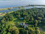 Set on a serene 11+ acre waterfront parcel on the coveted Gold Coast of Long Island, The Manor at Lands End stands as one of the last truly prestigious estates of its kind. This breathtaking compound, steeped in history, offers a rare opportunity to own with limitless views of Frost Creek and the glistening Long Island Sound. Originally a circa 1850 farmhouse, the estate was reimagined by the renowned architectural firm Walker & Gillette into the magnificent Georgian Colonial mansion that graces the property today.Spanning 13, 000 sq. ft., the stately Manor Home is an architectural masterpiece, featuring exquisite original millwork, soaring ceilings, and an abundance of natural light. The grand formal rooms are perfect for hosting, including an expansive living room with a regal fireplace, a wood-paneled library, an elegant dining room, and a sunroom that captures sweeping views of the surrounding gardens and waterfront landscape. The home is further enhanced with luxurious details such as hand-painted murals, wide plank hardwood floors, and a dramatic spiral staircase beneath a stunning domed skylight. The eight spacious bedrooms, most with private en-suites, include a spectacular Primary Wing with two sitting rooms, &rsquo;his-and-her&rsquo; dressing rooms, and two marble bathrooms. For staff or guests, the home offers a private two-bedroom apartment, with separate access for ultimate privacy.The estate&rsquo;s grounds are equally impressive. Designed by the legendary Frederick Law Olmsted, the landscaping is a true work of art, including a fragrant English garden, a walled rose garden, and expansive vegetable and herb gardens. Included in the Historic Gardens Registry at the Smithsonian Institute, the lush scenery overlooks the North Shore coastline and offers complete tranquility. The beautiful brick-columned pool house, with views of the sparkling in-ground pool and spa, is the perfect retreat for relaxation during the warmer months.This incomparable home is located within proximity to the Village of Locust Valley and several internationally acclaimed golf courses and private country clubs. With its impeccable gardens, tranquil pastures, oversized entertaining stone patios, and radiant waterfront views, The Manor at Lands End offers an unparalleled opportunity to own a piece of Long Islandâ€™s rich history. This is more than a home; it is a sanctuary - a place of beauty, privacy, and legacy that will last for generations to come.