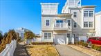 This turnkey, fully integrated smart home offers a unique blend of modern technology, comfort, and spacious living across a 2-family layout. Tons of space in the 3 level ownerâ€™s unit including 4 bedrooms and 3 full baths as well as a bonus loft with a walk in closet and a 524 square foot rooftop offering a stunning Ocean view. This property is perfect for multi-family living or rental opportunities. The home spans 2, 414 sqft of meticulously designed interior space, featuring radiant heated flooring across five zones, including the foyer, kitchen, dining area, living room, and bathroom on the first floor. High-end finishes are found throughout, including engineered wood flooring (3/4 thick, can be sanded and refinished) and Corian stairs. The kitchen boasts premium Quartz countertops from Bullstone Stone and Tile, with a red heated surface flooring for added comfort. Miele appliances, including an electric stovetop and innovative dishwasher, elevate the culinary experience.The home is energy-efficient, featuring fully paid-off solar panels installed in 2021, which produce approximately 125% of its energy needs, with a potential surplus due to the homeâ€™s recent vacancy. Two separate gas and electric meters make it ideal for rental, and the tenant currently pays $2, 150/month plus utilities, while the landlord covers water.Additional features include a 900lb safe in the pantry, a luxurious jacuzzi tub on the second floor, and high-quality European-imported interior doors. The property sits on a spacious 16â€™x 244â€™ lot with a full sprinkler system for the yard and a remote-controlled jacuzzi included in the sale, just 3 years old. The home also offers peace of mind with a 421 tax abatement, expiring in 2032, and a low HOA fee of $175/month that covers grass and snow removal.Additionally, the property includes a one-car garage and an extra parking spot, providing convenience and security.This home offers the perfect combination of smart home technology, high-end design, and rental potential.