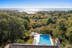 Discover a hidden gem with breathtaking water views in the exclusive Sandringham Beach community of Southampton! Located just two blocks from the private easement to Shinnecock Bay Beach, this 4-bedroom, 3.5-bathroom home is a rare opportunity to create your dream Hamptons retreat.With modern elegance and seamless indoor/outdoor living, enjoy panoramic water views from the kitchen, living room, dining room, and the expansive 50-foot deck. Step outside to overlook your 20x40 in-ground pool, featuring a new natural gas heater and a Nature 2 filtration system, which requires less chlorine for easier maintenance.Inside, the grand foyer opens into a large great room with endless views of Shinnecock Bay. The great room also features a fireplace with a natural gas hookup for cozy evenings and is set off of the open concept kitchen, perfect for entertaining. The primary ensuite featuring a spacious bedroom with water views, offers a luxurious escape with a jacuzzi, shower, and private balcony. For added privacy, guests can enjoy a separate gated entrance to their rooms, with sliding glass doors that open to the lower deck, pool area, and Dimensions 2 hot tub.Additional features include a private driveway which can fit five cars, a 2.5-car garage, Anderson storm windows throughout, a fireplace with natural gas hookups (which also services the kitchen stove and Generac), and a 7-zone sprinkler system. The enormous laundry room rounds out the home with a new washing machine, refrigerator, sink and ample storage closets. Outside, lush gardens featuring plenty of specimen trees, raised organic garden bed, serene walking paths, and multiple patios offer a tranquil setting for relaxation.Sandringham Beach community is located south of the highway, just minutes from Southampton Village and Ocean beaches. Additionally, it&rsquo;s the first stop off Route 27 when coming from the city, allowing you to avoid any additional summer traffic. Most notably, this property offers the unique potential to expand to a third level and add an upper deck (all without the need for a variance as you wouldnâ€™t break the roof line). This home truly is a canvas for your vision, ready to be transformed into your ideal retreat.Donâ€™t miss the chance to transform this property into the ultimate Hamptons getaway!