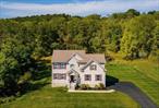 Located in the desirable Highgrove community in Washingtonville, this stunning colonial sits on a premium tree-lined homesite with sun-drenched rooms throughout. Its southern exposure fills every space with beautiful natural light and the open floor plan offers a seamless flow, ideal for both everyday living and entertaining. Features include hardwood flooring throughout, a chef&rsquo;s kitchen with a large center island, granite countertops, SS GE appliances, and ample work space, an open dining room, and a living room with a volume ceiling, wall of windows and gas fireplace. The primary suite is a private retreat with dramatic vaulted ceiling, two walk in closets, and a spa-like bath complete with a whirlpool tub, double vanity and separate tiled shower. Also included is a full, unfinished basement equipped with under-slab rough-in plumbing for a future bathroom, egress window, and a walk out, offering an excellent opportunity to create future additional living space. The outdoor living is just as impressive, with a two-tier composite deck overlooking a beautiful pool and private backyard. This home was built in 2019 to high performance energy efficient specs and offers fully owned solar panels, dual-zone heating and air conditioning, custom irrigation system, and exterior lighting. All of this just 50 miles to Manhattan, offering an ideal commute for NYPD, FDNY, and city professionals. This truly is an exceptional home in a sought-after community-a place you&rsquo;ll love to call home! See floor plans and video.