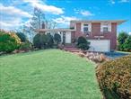 Split Level Home on oversized park like property, featuring Syosset Schools, 4 bedrooms, 2.5 baths, newly updated large eat-in kitchen, dining room, Living Room, hardwood floors,  2 car garage, close to schools, LIRR, major highways, shopping and restaurants