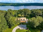 Capturing a spectacular 180-degree view of the Titicus Reservoir, this modern farmhouse is set atop 49 acres. The home designed by local architect Phil Franz, is perfectly positioned on the land. The interior design is tasteful, richly detailed, and flooded with natural light. A handsome main staircase frames a wide entry hall. Beamed and cathedral ceilings, extensive built-ins, and gleaming hardwood floors are all the hallmarks of the quality of the build. French doors open out to a broad stone terrace from the living room, breakfast room and primary bedroom. All of the first floor rooms including the primary suite face south towards the awesome view. Grass paths wind through glorious gardens to a kidney shaped pool and spa. Woodland trails are maintained throughout the property and lead to the the North Salem bridle trails. Private, serene and simply beautiful, this is a very special offering and an extremely rare opportunity with room for additional development. Just minutes from the hamlet of Purdys and the Metro North train station and 50 miles from Midtown Manhattan. Have lunch at Farmer and The Fish and live your best dream in wonderful North Salem.