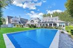 An extraordinary waterfront retreat set on 3.5 acres, featuring a saltwater pool and private dock. Nestled in an exclusive estate setting, this meticulously custom-built residence offers breathtaking water views and 290 feet of prime waterfront access, complete with a deepwater dockâ€”ideal for boating enthusiasts. Crafted with precision and exceptional designer finishes, this home boasts a soft, modern interior flooded with natural light, large windows, and glass doors that frame stunning panoramic water vistas. The expansive great room, with its soaring ceilings and grand fireplace, is complemented by a custom gourmet kitchen equipped with top-of-the-line finishes. The open layout seamlessly connects the kitchen to the dining and living areas, creating the perfect space for both intimate meals and grand entertaining. Luxurious bathrooms with radiant heat further enhance the appeal. The lower level of the home is an entertainerâ€™s dream, offering an expansive space designed for ultimate relaxation and fun. Featuring a custom-built bar, itâ€™s the perfect spot for hosting friends and family, with sleek finishes and ample seating for everyone. A spacious game room provides plenty of room for various activities, making it ideal for movie nights, pool or billiards, and more. Large windows and a walk-out door allow natural light to flood the space, creating a bright and inviting atmosphere. Outside, enjoy the heated gunite pool by the water and the meticulously manicured grounds. This waterfront oasis embodies refined, unparalleled luxury, offering the ultimate in waterfront living and every amenity imaginable.