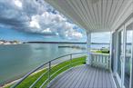 Just a ferry ride from Sag Harbor and the Hampton&rsquo;s, take in expansive waterfront views of the bay and Greenport harbor from the second floor balcony in this renovated open concept waterfront condo located in the private Stirling Cove condominium association. This light filled townhouse offers a private beach, 60&rsquo; x 30&rsquo; heated pool overlooking the bay, two tennis courts, private parking and is two blocks from the heart of Greenport Village and Mitchel Park. Perfect for enjoying the renowned restaurants, shops, parks, marinas and other attractions Greenport Village has to offer without the hassle of searching for a two hour parking spot. Appliances included are a washer/dryer, dishwasher, stove, microwave, refrigerator. Rental Permit # 23317, June $7, 000 July $12, 000 August $14, 000