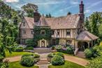 A majestic move-in ready French Normandy Tudor that boasts tremendous flexibility in layout, adaptable spaces and every modern convenience. Recent structural renovations and fresh cosmetic restorations to inside & out establish this 1927 home as a timeless masterpiece for the 21st century homeowners needs. The elegant mature landscape, designed by renowned horticulturist Timothy Tilghman, always guarantees a swoon worthy first impression. This iconic 6 bedroom/5.2 bath house simply awaits the next homeowners&rsquo; personal touch. High ceilings, oak beams and restored woodwork adorn the interiors. The stone entry turret leads into a charming gallery, sunken living room with wood-burning fireplace & private home office with doors to front/back terraces. A spacious library w/ carved stone wood-burning fireplace & large, elegant dining room w/ leaded glass windows & doors open to a newly constructed eat-in kitchen & family room designed by London-based Smallbone of Devizes. With true indoor/outdoor egress, the kitchen area steps down to a 575 SF patio, designed for multi-season entertaining. A mudroom/garage and back stair connects 1st floor to lower level which houses a theater/playroom, climate-controlled wine cellar, large gym/Pilates space with bathroom & laundry area. The second floor presents a sophisticated, elegantly-appointed primary wing which includes an Architectural Digest-worthy bedroom with sitting room, dressing area with wood-burning fireplace, ensuite renovated bathroom and custom-built closets and cabinetry. Additionally, four family bedrooms plus a wealth of spaces that can be personally curated to serve as a homework room, yoga studio or office. There are also 3 renovated full bathrooms, plus a private deck with hot tub overlooking the gardens.The 3rd floor offers an ensuite bedroom with renovated bathroom, media/music room and custom craft/project studio. Enjoying .66 acres of level land, this sensational property with a premier address is steps from school, train, and town, offering the best in Bronxville living.