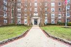 This stunning apartment showcases exceptional design and offers a bright, airy atmosphere with exposure on three sides. The entryway leads to a spacious living room and dining area, featuring a cozy wood burning fireplace. There are two generously sized bedrooms, which have a charming French door that opens to a lovely balcony with 4 sizeable closets. The unit includes two full bathrooms and versatile bonus room suitable for a den, office or nursery. Highlights of the apartment include high ceilings, original oak flooring, ample closet space, and numerous windows that fill the space with a natural light. Residents of the Lexington House enjoy a range of amenities, such as a part-time doorman, a live-in superintendent, free storage, a rooftop solarium, and complimentary bike room. The location is convenient, with express subway access at 71 Continental Ave, LIRR, and proximity to the historic West Side Tennis Club. This property truly embodies comfort and palatial in a prime setting.