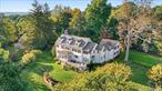 Welcome to 2 Belmont Drive, located in the prestigious Ardsley Park neighborhood of Irvington. Set on 1.3 acres of park-like grounds, this exceptional property boasts breathtaking views of the Ardsley Country Club. As you step through the grand, double-story entry, the quality and craftsmanship of this expansive 6, 400-square-foot Colonial home is immediately evident. The chefâ€™s kitchen is equipped with top-of-the-line stainless steel appliances and features an oversized quartz islandâ€”perfect for entertaining, family gatherings, and meal preparation. Start your day with a cup of coffee in the sun-drenched breakfast area, which seamlessly flows onto a spacious stone patio, complete with a motorized awning for added convenience. The main level also offers an elegant formal dining room, a large, light-filled home office, and a beautiful living room featuring an arched entryway and a cozy fireplace. The expansive family room, with custom built-in cabinetry and a wall of windows, provides sweeping views of the meticulously landscaped grounds. Designed for convenience, the main level also includes a newly designed mudroom, featuring custom cabinets, shelves, and ample hooksâ€”ideal for managing shoes, coats, and backpacks. A stunning new powder room, complete with a Kast concrete sink, adds a touch of luxury. The second level is dedicated to rest and relaxation, offering an exceptionally tranquil primary suite with a spa-like bathroom and two custom walk-in closets. Three additional spacious bedroomsâ€”one with an en-suite bathroomâ€”share a beautifully appointed hall bath. A generously sized laundry room and a versatile bonus room, perfect as a guest suite, studio, or playroom, complete this floor. The walk-out lower level adds an impressive 1, 900 square feet of additional living space, including a professional wine cellar. This home also offers the unique opportunity to choose between the award-winning Irvington or Dobbs Ferry school districts. Experience the seamless blend of luxury, comfort, and privacy at 2 Belmont Driveâ€”your dream home awaits.