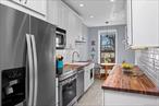 Enjoy panoramic views and sunsets in this airy, sun-drenched 2 bedroom corner pre-war gem, a rare in-unit washer/dryer (grandfathered), parquet floors and a renovated kitchen with butcher block counters and top-of-the-line stainless steel appliances. The apartment has a king-size primary bedroom, spacious living room with high ceilings, and exquisite pre-war details. The bathroom is fully updated, and there are ample closets throughout and 9 windows. Private storage unit for rent is available.Set in one of Shore Roadâ€™s most desirable and well-maintained pre-war buildings, 9701 has a fantastic live-in super and is pet-friendly. Located directly across the street from Shore Road Park with its new playground and dog run, scenic waterfront paths, tennis courts, and fields.The monthly maintenance covers all utilities including electric, water, heat, and real estate taxes â€” one simple bill, even air conditioning is only $60 per year per installed unit. Extremely rare, 10% down payment possible for qualified buyers. Conveniently located near express buses - just 30 minutes to Wall Street - the R train, and wonderful shops and restaurants, this is a rare opportunity to own a beautifully updated home in a truly special building.