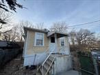 Welcome to this charming home located in the sought-after Pelham Gardens section of the Bronx. The first floor features a comfortable layout with 3 bedrooms, a living room, Kitchen, Dining area and a Two bathrooms. Lower level boasts 2 bedrooms, a living room, a dining room,  kitchen, and 2 bathrooms, providing ample space for a growing family or rental opportunity.This property also includes the convenience of a detached indoor 2-car garage, offering parking and storage solutions for residents. With its prime location in Pelham Gardens, residents can enjoy easy access to local amenities, parks, and transportation options.Property has open violation and open permit Selling AS IS Additional Information: Amenities: Storage, Parking Features 2 Car Detached,