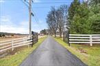 Tucked away behind!!! Enter through a gated entrance, this stunning 100 +/-acre farm is a private oasis offering breathtaking open meadows and a tree-lined driveway leading to an 1850s farmhouse filled with charm and character. The home features wide plank floors, a striking stone fireplace, a country kitchen, updated bathrooms, and a rocking chair porch perfect for relaxing and taking in the peaceful surroundings. The property includes run-in sheds, horse fencing, multiple paddocks, and a massive barn with electricity, eight stalls, and ample space for storage or livestock. A dog kennel adds even more versatility to this exceptional farm, providing endless opportunities for animal lovers. Ideally located just minutes from Pine Bush Village, shopping, restaurants, and the scenic beauty of Cragsmoor, this remarkable property offers a rare combination of seclusion, convenience, and endless possibilities. Buy this farm!