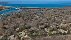 A Thousand Feet to the Harbor - All about the address. Super quiet country lane runs gently downhill to Three Mile Harbor. This classic Hamptons saltbox-style home offers 1, 600 sq. ft. of comfortable living space across two stories with 4 bedrooms and 2 bathrooms. The main level features an eat-in kitchen and a bright living room with double-height ceilings and sliding doors leading to a spacious deck. Outside, enjoy a large fenced backyard with a pool and jacuzzi, perfectly positioned with west-facing exposure for beautiful sunset light. A quick trip to the bay beach with all amenities.