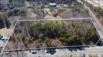 Corner of Long Island Expressway S Service Road and Bellport Rd. 3.14 acres of uncleared, unimproved land. Zoning currently is A1 residential. Zoning change would need to be cleared with the town. Possible potential for housing development, convenience store, public storage or gas station with zone change. May be subdivided into 3 lots. Proper address is Long Island Ave, but the location is not actually on that road.