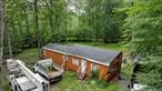 A charming Modular Home on 2.7 Acres in Ellenville School District Nestled on a sprawling 2.7-acre lot, this cozy modular home offers a unique opportunity to create your dream living space. While modest in its current form, the home is a blank canvas with incredible potential for those with a vision. Whether you&rsquo;re looking to expand, add custom features, or even start fresh with new construction, the possibilities are endless. The property is surrounded by nature, providing a sense of privacy and tranquility that&rsquo;s hard to find. Imagine enjoying your morning coffee while watching the sunrise over your expansive backyard or hosting summer gatherings in your own secluded oasis. Located in the desirable Ellenville school district, this home combines the charm of country living with the convenience of being just a short drive from local amenities. Don&rsquo;t miss the chance to make this property your own and create the home you&rsquo;ve always envisioned. This is more than just a houseâ€”it&rsquo;s an opportunity to build your future.