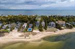 Perfect year-round residence or Summer getaway! Beachfront approx 3000 sqft home on 1.3 acres with 50ft of sandy beach. Set back from road, providing an abundance of parking, featuring a sun-filled interior with hardwood floors, foyer with coat closet, first floor bedroom/office, updated electric and new HVAC. Enter to expansive 26&rsquo;X27&rsquo; living room, glass sliders to patio, and walls of windows perfectly frame views across Northport Bay to the Vanderbilt Museum. 2 car garage off kitchen and adjoining dining room with water views. Custom reclaimed wood floating staircase leads to second level which encompasses primary en-suite featuring a 26&rsquo;x13&rsquo; balcony with captivating sunsets overlooking the water. The primary suite also includes a tray ceiling, walk-in closet, and marble bathroom with water closet, dual sinks, and radiant floor heat throughout. Laundry room, 2 additional bedrooms, one with a private balcony, and hall bath complete the second level. Situated in the Village of Asharoken, this one-of-a-kind oasis is just 5 miles to Northport Village with Broadway acclaimed theater, restaurants, brewery, and park, plus nearby vineyard/winery, schools, and golf course. Incredible opportunity to live amongst and enjoy the amenities of Long Island&rsquo;s North Shore. Total taxes $24, 498.52