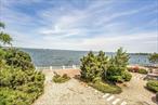 This rare opportunity nestled in the Enchanting Country Club Beach Estates Condominium- Waterfront - ground level unit- boasts an open & airy floor plan-  Layout features: Entrance foyer w/closet, EIK seating for two, dining area, bathroom,  living room with Fireplace w/breath taking views & w/sliding doors out to terrace with spectacular Water Views & water access of the Long Island Sound and a private beach for residents- tile terrace to enjoy relaxing in the morning having coffee watching the sunrise or in the evening having a glass of wine watching the sunset, Primary Bedroom w/bathroom & 2nd bedroom. Unit has 1 assigned parking spot, laundry in unit, accessible to NYC Express bus, local buses, stores, highways and restaurants. Paradise awaits with this fabulous Condo for you to call home and add your personal touches to. Please call for your private showing......