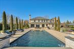 Summer is here! It&rsquo;s time to entertain in this gorgeous yard! Welcome to 116 Carman Road, an architectural French Colonial masterpiece built in 2019, offering 5 bedrooms and 6 bathrooms and features 10&rsquo; to 12&rsquo; ceilings on all three floors, in the heart of Dix Hills. This custom-built 6300 sq. ft. estate with a 3000 sq. ft. basement was designed with top-tier materials from around the world, blending elegance, technology, and luxury living. Step into the grand entryway featuring a 30-foot ceiling with marble flooring and a breathtaking Mahogany three-story staircase with custom chandelier. The home is accentuated by custom millwork, premium wood flooring, intricate coffered ceilings and radiant heated flooring on the entire first floor. Every room is outfitted with built-in speakers, high-end finishes, and a smart home system controlled via a commercial-grade server housed in the expansive basement.The chefâ€™s kitchen is a culinary dream, boasting custom maple cabinetry, Blue Star 8-burner range and Blue Star hood, Bosch dishwasher, Miele coffee maker and warming drawers, a Sub-Zero refrigerator, freezer and wine cooler with two drawers, and a walk-in pantry. A whole-house water filtration system ensures the highest quality water, while the reverse osmosis system in the kitchen provides pure drinking water. The butlerâ€™s pantry provides additional convenience, while True Stile 8-ft doors and solid brass Baldwin hardware add an element of timeless elegance throughout the entire house. There is a full wet bar with beautiful mosaic flooring in the family room and a marble wood-burning fireplace perfect for entertainment. The primary suite is a retreat of its own, featuring a gas fireplace, his & hers walk-in closets with auto-locks, a spa-inspired marble ensuite with a steam shower, soaking tub, and dual vanities, plus an exclusive bonus room. Each additional bedroom offers an ensuite marble bathroom and walk-in closets, ensuring privacy and comfort. The 3000 sq. ft. basement is partially finished with a media room/office that features French doors leading out to the sunken patio and the hot tub. The mechanical room is an engineers dream done to perfection with every bell and whistle you could ask for. The unfinished portion is waiting for your design and has 12&rsquo; ceilings is some areas (great for a golf simulator). Dream BIG for this extra 2500 square feet of blank canvas to work with!Outside, the custom-developed backyard is a private paradise reminiscent of The Great Gatsby, featuring a 20x44 gunite pool with an 8-ft jacuzzi (saltwater, heated, UV & ozone purified), a cool sunken patio with a very private Bull Frog M8 hot tub, and wrought iron estate fencing all around. The meticulously designed, landscaped property creates the ultimate outdoor living and entertainment space for hosting gatherings and tranquil relaxation. Additional highlights include whisper-quiet garage doors for the 3-car garage, spray foam insulation (great HERS score), and a fully alarmed security system with glass break sensors. See amenities list for many more details of this home.A true fortress of luxury and innovation, 116 Carman Road is one-of-a-kind and ready for its next owner.