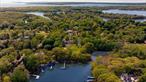 For the first time in over a century, this extraordinary collection of generationally owned properties is being offered together as a singular and rare opportunity. Nestled along the serene and picturesque Menantic Creek, these three separate parcels combined total 4.9 acres, which have been combined into one sale, presenting an unrivaled waterfront retreat. The Menantic Creek, known as Hurricane Hole for boat protection during storms, offers boating access to both the North and South Forks and a short run to Montauk. For the boating enthusiast, this offering includes a 100-foot stationary dock, complete with a 6-foot-wide walkway with a bench, as well as a 12-foot plastic ramp leading to a 30x6 ft. floating dock with three anchor pilings. Two moorings on the creek are also available, pending reapplication.At the heart of this offering is 15A Menantic Road, a legally designated two-family residence with a breathtaking 3, 944 square feet of meticulously renovated living space. This refined home features five bedrooms, 4 plus 2 1/2 baths, and a 483-square-foot garage, all thoughtfully designed to maximize the stunning creek views. Taxes: $12, 206.00Adjacent to this residence is 15 Menantic Road, a pristine and vacant 1.3-acre parcel, offering endless potential to further enhance this exceptional estate. Taxes: $4, 325.00Completing the trio is 13 Menantic Road, a charming 1930s bungalow with two bedrooms and one bath set on 1.47 acres and a brand new two story 4 bedroom, 2.5 bath home with attached two car garage in the final stages of completion. Taxes: $8, 521.00What truly sets this estate apart is its extraordinary arboretum-like setting, adorned with a curated collection of rare and mature specimen trees, including Copper Beech, Southern Magnolia, White Birch, Monkey Puzzle, Dawn Redwoods, Linden, Osage Orange, Red Japanese Maple, and Dogwood. The natural beauty of this land is simply unparalleled.This is a once-in-a-lifetime opportunity to own a waterfront compound with limitless potentialâ€”a legal multi-family residence, a historic bungalow, a new construction home and an untouched parcelâ€”all in one of the most coveted locations. A truly rare find for the discerning buyer seeking exclusivity, natural beauty, and unparalleled waterfront living.