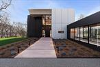 A one-of-a-kind modern masterpiece overlooking Stony Brook Harbor, this new construction home with its striking design is a beautiful juxtaposition of its natural surroundings. Designed by visionary architect, Bob King, this home is a perfect blend of industrial strength and modern elegance. The only home in the region that is wrapped in high-performance aluminum composite paneling, the exterior is not just stunning - it is virtually maintenance-free and engineered to stand the test of time. Spanning over 6, 500 interior square feet across three floors - there are five bedroom, five bathrooms, a magnificent column free 50ft x 40ft great room, lower lever with walk-out deck, wine cellar, panic/safe room, and a futuristic glass enclosed link that seamlessly connects the main residence to the four-car garage. They layout has been thoughtfully designed for both form and function. Perched on a hill near the Stillwater Road cul-de-sac, the lot is uniquely position to have a southern exposure with breathtaking water-views which is extremely rare on the north shore. Benefits of a southern exposure on this part of Long Island include increased natural light throughout the day and less wear and tear on the exterior of waterfront homes from harsh weather. Whether you walk in through the front door or use the glass link - you&rsquo;re immediately greeted by an expansive great room with an open kitchen / dining area, fireplace, custom 10 ft windows, massive wraparound terrace, and gorgeous views of the harbor and Nissequogue golf course.On the second floor - there are a total of 3 bedrooms, each with it&rsquo;s own ensuite bathroom. The primary includes a large walk-in closet, floor to ceiling windows, and a wraparound balcony. The lower level features a beautiful open room with fireplace that can be used as a rec room, home theater, gym, etc. There is two additional bedrooms with water views, a full bathroom, panic room / home safe, and a wine cellar. This level also walk out to the deck where plans are in place for the new homeowner to finish an outdoor entertainment space to their liking which can include a sauna, hot / cold plunge, and an infinity pool. All major systems are in place - power, radiant heated floors, plumbing, electrical, insulation, and ductwork - with a fully completed exterior. Whats remains is the exciting part: bringing the new homeowner&rsquo;s personal vision to life. Interior and pool renderings offer a glimpse of the extraordinary possibilities ahead.