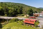 Exceptional Village Investment with Airbnb Track Record & Expansion Potential Welcome to Windham, where modern luxury meets country charmâ€”just steps from ski slopes, golf, restaurants, wine bars, and the NYC bus line. Set along the tranquil Batavia Creek, this beautifully renovated home is both a proven short-term rental success and an incredible four-season getaway. Currently operating as a high-performing, exceptional Airbnb, the property offers: Two private ensuite bedrooms with spa-style baths Radiant floor heating, a dramatic stone fireplace, and an open-concept layout ideal for entertaining Seamless indoor-outdoor living with a covered patio, new hot tub, firepit, and peaceful creekside views Accessibility features including wider entryways and a walk-in shower.Consistent 5-star guest reviews and strong year-round rental demand Investor upside: The property includes three separately deeded parcels with completed site plansâ€”offering potential to build a second home or expand, adding further value and income opportunity. Whether you&rsquo;re seeking a turnkey rental, personal retreat, or long-term investment with room to grow, this rare offering delivers it allâ€”in one of the Catskills&rsquo; most desirable and walkable locations.