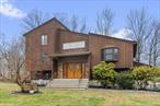 Stunning Contemporary Home in Cortlandt Manor â€“ 2, 700 Sq. Ft. on a Beautiful 1-Acre Lot!This spacious four-bedroom, three-bathroom contemporary home offers modern comfort, timeless elegance, and a prime location. Situated on a level 1-acre lot, the property is beautifully landscaped with lush greenery, creating a serene and private retreat.Step inside the bright and inviting Interior, into to an open-concept layout filled with natural light. The spacious living room features large windows and a seamless flow into the rest of the home. The chefâ€™s kitchen modern appliances, granite countertops, custom cabinetry, and a charming breakfast nook, making it the perfect space for both cooking and entertaining.The downstairs family room is a cozy yet functional space, featuring a fireplace and direct access to the patio and backyard. Ideal for relaxing evenings or hosting guests, this room enhances the homeâ€™s warmth and charm.The luxurious master suite serves as a private retreat, complete with an en-suite bathroom and a walk-in closet. The additional bedrooms are generously sized, featuring large windows and ample storage to accommodate family and guests comfortably.This home truly shines outside, with a spacious deck, stone patio, and manicured landscaping creating an outdoor oasis. Whether hosting gatherings, enjoying morning coffee, or simply unwinding, the outdoor spaces provide the perfect setting. The underground utilities maintain a clean and unobstructed landscape, adding to the homeâ€™s curb appeal.Conveniently located near top-rated schools, shopping, dining, and major highways, this home offers both convenience and tranquility. With easy access to Metro-North and major roadways, commuting to New York City and surrounding areas is effortless.Donâ€™t miss this incredible opportunity to own a beautiful home in one of Cortlandt Manorâ€™s most desirable neighborhoods! Schedule a private showing today!