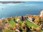 Welcome to 31 Fort Hill Drive, a landmark estate perched atop 10 private acres in the prestigious enclave of Lloyd Harbor. Set across two parcels with 1, 800 feet of private beachfront and a deep-water dock, this extraordinary compound offers uninterrupted, panoramic views of the Long Island Soundâ€”widely regarded as among the finest vantage points on the North Shore.Steeped in natural beauty and rich American history, the estate sits on Fort Hill, a site of Revolutionary War significance where signal beacons once watched over the Sound. Today, the same elevated terrain offers a rare sense of seclusion, grandeur, and sweeping coastal vistas that change with every season and every tide.This custom brick residence is a masterwork of craftsmanship and scale, featuring 13 bedrooms, 10 full bathrooms, and four half baths. Elegant interior spaces include a sunlit solarium, a stately library, and an expansive, exquisitely detailed ballroom designed for unforgettable gatherings. Seven fireplaces, intricate millwork, and curated architectural details throughout add a sense of timeless refinement.A fully renovated gourmet kitchen anchors the homeâ€™s living spaces, offering high-end appliances, classic finishes, and effortless flow into formal and informal dining areas. Whether youâ€™re hosting intimate family dinners or large-scale entertaining, the home rises to every occasion.Additional amenities include staff quarters, a 16-car garage with guest apartment suites above, a state of the art geothermal system, and flexible bonus rooms ideal for a private theater, wellness space, or art studio. Outdoors, a 3-acre curated garden with a greenhouse, invites peaceful strolls and moments of serenity amidst manicured plantings.From sunrise over the water to evenings under the stars, this is a home where every day is defined by natural splendor, privacy, and possibility. Just moments from Huntington Village and the train to NYC and located within the award-winning Cold Spring Harbor School District, 31 Fort Hill Drive is more than a homeâ€”itâ€™s a legacy estate where history, beauty, and lifestyle converge.