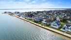Welcome to unparalleled waterfront living in the prestigious Shinnecock Shores community of East Quogue, Southampton. This brand-new, 3, 900-square-foot masterpiece by ARC Restoration & Development offers 75 feet of private beach access with an updated bulkhead, delivering breathtaking panoramic views of Shinnecock Bay from nearly every room. The open-concept layout features a chefâ€™s kitchen flowing seamlessly into the living and dining spacesâ€”perfect for both everyday comfort and stylish entertaining.With 6 spacious bedrooms and 5.5 designer bathrooms, including two luxurious primary suites with private balconies, this home balances privacy with open, light-filled living. An additional upstairs living area provides the perfect setting for relaxation or hosting guests. Meticulously designed with triple-glazed windows, smart home technology, and high-end finishes throughout, the home also incorporates sustainable elements like a nitrogen septic systemâ€”offering modern luxury with a thoughtful eco-conscious edge.Set in a private waterfront enclave with community amenities including a bay beach and playground, this fully furnished and professionally decorated retreat is ready for immediate enjoyment. Landscaping and driveway completion are slated for Spring 2025, making this extraordinary coastal haven the perfect place to unwind, entertain, and call home.