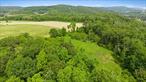 30 Acres of Prime Land with Panoramic Mountain Views & Walking Distance to Downtown Millerton!A rare and remarkable opportunity to own 30 acres of pristine, gently rolling land just steps from the heart of Millerton in the Town of Northeast, Dutchess County. Perched atop a rise with unobstructed 360-degree mountain views, this exceptional parcel is ideal for a private estate, family compound, or thoughtfully planned subdivision. The roughed-in driveway provides easy access to the highest point, making site visits and future development seamless. Bordering scenic farmland and directly fronting the Harlem Valley Rail Trail, the property offers a perfect blend of serenity, walkability, and recreation. A picturesque stream flows across the street, enhancing the already idyllic setting.Enjoy all the charm and convenience of Millertonâ€”just a few minute walk to popular destinations like Irving Farm Coffee House, The Oakhurst Diner, The Moviehouse, and the bustling Saturday farmers market.Whether you&rsquo;re looking to build your dream retreat or invest in a high-potential property in a thriving, community-focused town, this land offers unmatched value, vision, and versatility.Opportunities like thisâ€”acreage with views, walkability, and rail trail accessâ€”are vanishingly rare. Donâ€™t miss your chance to secure a generational property with million-dollar vistas!
