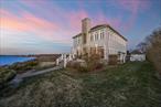 Southold, North Fork. This exceptional waterfront estate features a private beach on Long Island Sound and offers stunning sunsets that enhance its luxurious, resort-like atmosphere. Conveniently located between the vibrant maritime village of Greenport and the charming hamlet of Southold, .71 acres of level land designated as a FEMA safe zone (Zone X). With approximately 78 feet of bulkheaded waterfront, the residence is elevated on a promontory to capture breathtaking views of the beach and the Connecticut coastline. The open floor plan is perfect for entertaining, allowing every room to showcase spectacular vistas. A grand foyer greets guests, leading to a sunlit living room with fireplace and beachside terrace access, complemented by a spacious dining room and den. The gourmet kitchen is a chef&rsquo;s dream, featuring premium stainless-steel appliances, sleek stone countertops, and a mosaic backsplash. The main floor includes a stylish guest bathroom and an ownerâ€™s suite with a full bath. Upstairs, the expansive second-floor ownerâ€™s suite boasts a fireplace, a luxurious full bath, and a walk-in closet that doubles as an office, along with two additional en suite bedrooms. Additional highlights include a large four-car garage, a long, gated driveway amidst lush lawns with room for a pool, and a secluded sandy beach, offering an idyllic retreat for those who appreciate waterfront living at its finest