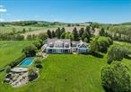 Nestled on top of Carpenter Hill, with unparalleled views of Stissing Mountain, the Catskills and the surrounding farmland, sits this country estate on 24.78 acres. The traditional, cedar shake 6, 310 square foot home exudes elegance exhibited through the well proportioned rooms with 9â€™4â€ ceiling height, exceptional craftmanship and attention to detail found throughout the home. A dramatic double height foyer leads to the gracious living room which features a wood burning fireplace, built-ins, a cozy window seat and French doors that open to a covered porch. Lots of natural light floods into the family room through the walls of windows with western views. The chefâ€™s kitchen boasts custom finishes, top of the line appliances, an impressive river stone matte finish granite island, pantry and opens to the spacious dining area. Three sets of French doors open to two covered porches, added in 2021, seamlessly blending indoor-outdoor living. The second floor provides the primary ensuite, two bedrooms and a full bath. Connecting the main house to the guest wing is an attractive, yet functional, mudroom with bluestone floors. The guest wing was added in 2001 and includes a foyer, kitchenette, first floor ensuite bedroom, and a second floor bedroom and bath. In 2015, a two car garage with studio above was added, creating a beautiful space for working from home, the possibilities are endless. The manicured property offers perennial gardens that bloom throughout the season. There is a gunite pool that is seamlessly blended into the landscape to embrace the surrounding vistas. Truly a remarkable property offering peace and privacy with spectacular views.
