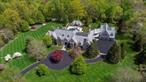 Behind the gates of one of Bedford&rsquo;s most exclusive enclaves, rises this breathtaking English Manor estate designed by renowned architect Tasos Kokoris. This architectural gem offers unparalleled privacy, luxurious resort-style amenities, and a coveted location - just under an hour from Manhattan. Set on over five acres of flawlessly landscaped grounds, the home is a statement of timeless sophistication and superior craftsmanship. Inside, soaring 10 to 12-foot ceilings, intricate custom millwork, and designer finishes create a sense of grandeur. A new Deane kitchen anchors the heart of the home, while thoughtful additions such as an elevator, full gym, sauna, wine cellar, theater, and guest suite enhance its lifestyle offerings. A cherry-paneled library hides a dramatic stairway leading to a magnificent primary suite, complete with dual spa bathrooms, expansive walk-in closets, and a serene, glass-wrapped sitting room. Perfectly tailored for both large-scale entertaining and quiet moments, the outdoor living spaces feature a heated 40x20 PebbleTec saltwater pool, 14-person infinity-edge spa, and a luxurious pool cabana with a summer kitchen and full amenities. Enjoy a three-season screened porch, limestone terrace, lush gardens, and even your own private golf practice area. A showroom-style garage for nine cars complements the main residence&rsquo;s attached garage and is perfectly tailored for a luxury car collection or other uses such as an indoor sport court. Easy access to award-winning schools, top country clubs, fine dining, shopping, and Westchester County Airport. This is the pinnacle of luxury living in Bedford.