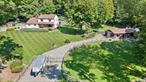 This exquisitely maintained four-bedroom, two-bathroom Colonial home offers a rare opportunity to own a turnkey equestrian retreat, combining classic architectural charm with thoughtful, high-end updates throughout. Nestled on a beautifully landscaped and tree-lined lot, the property exudes warmth, privacy, and rural elegance, making it an ideal sanctuary for both people and animals. Designed for serious equestrians, the estate features a fully outfitted four-stall barn, complete with a spacious tack room, ventilation fan, and hay storage capacity for up to 250 bales. Each stall is matted and features its own walkout, electric waterers, and innovative expandable doors that allow you to customize the space based on your horsesâ€™ needs. The grounds also include two large grass paddocks for grazing, a 60-foot round pen for training, a dedicated garden area, and a separate dog pen, offering a functional and flexible layout for a variety of outdoor lifestyles.Beyond its equestrian amenities, the property includes a series of charming and practical outbuildings: two large shedsâ€”both with new roofsâ€”one ideal for storing tractors, ATVs, or equipment, and the other transformed into a picturesque carriage house brimming with character. A stunning, fully restored 1890 style wooden silo, relocated from its original location, stands as a centerpiece of rustic beauty and history, complete with a handcrafted wooden staircase. The home itself has been meticulously updated to meet modern standards, including new windows, a recently replaced roof, fully renovated bathrooms, a newer furnace and water heater, and major mechanical upgrades like a 500-gallon propane tank and two 250-gallon above-ground oil tanks. A Wilco standby generator ensures year-round reliability, while the horse fencing has been thoughtfully wired between the rails for pet safety.Inside, the home offers warm, inviting living spaces filled with natural light and timeless design elements. A newly added four-season porchâ€”with a charming gas stoveâ€”provides a cozy, scenic space for relaxing or entertaining, offering panoramic views of the tranquil grounds. Every detail of this property reflects the care and craftsmanship of its original owners, who maintained it with the highest standards in mind. Whether youâ€™re a seasoned equestrian, a hobby farmer, or someone simply seeking a peaceful, picturesque lifestyle with modern comforts, this one-of-a-kind property seamlessly blends luxury, function, and pastoral charm in an unmatched setting. Property has deeded, limited access to the lake across the street (i.e. ice skating, swimming, etc). Located within 5 miles of I-84.