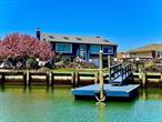 Waterfront Oasis in Oceanside â€“ A Rare Gem!Experience luxury living in this stunning 4-bedroom, 3-bath contemporary home situated on one of Oceansideâ€™s widest canals with a brand-new bulkhead. Boaters will love the oversized dockâ€”ideal for two large boats and easily expandable. Just minutes to the open bay!Enjoy resort-style outdoor living with a heated saltwater in-ground pool featuring a brand-new deep blue liner, surrounded by pavers that extend through the pool area and driveway. The professionally landscaped grounds include a lush lawn, rare conifers, vibrant flowers, Japanese Maples, and a private vegetable garden with a large double shedâ€”perfect for the green thumb. A 7-zone sprinkler system keeps the grounds looking pristine, and security cameras around the exterior offer peace of mind.Inside, the top floor offers an open, sun-drenched layout with soaring ceilings, skylights, and floor-to-ceiling windows. A formal living room with a built-in fireplace flows seamlessly to a massive new deck with sweeping water viewsâ€”an entertainerâ€™s dream. The updated kitchen features modern appliances, a large island, and generous prep space.The master bedroom includes two spacious walk-in closets and an oversized en-suite bath with a luxurious sauna shower. A second large bedroom and full bath complete the upper level. Downstairs, enjoy a spacious family room with sliders to the pool, two additional bedrooms, a full bath, and a large laundry room with second fridge and abundant storage.Additional features include a 2-car attached garage, an extra-wide driveway for three cars, and also boasts a boat. Homes like this rarely come to marketâ€”schedule your showing today and make waterfront living your reality!