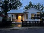 Stylized, Convenient, In-Town 1940s Cottage with Modern Updates & Endless Possibilities! Home went through complete renovation! Welcome to this beautifully updated 1940s cottageâ€”a perfect blend of classic character and modern convenience, right in the heart of town. With 2 spacious bedrooms and a renovated full bathroom, this home offers move-in ready comfort and style. The generous kitchen boasts modern appliances and ample space for cooking and gathering, while the light-filled insulated sunroom is your new favorite spot for morning coffee or an afternoon bookâ€”complete with doors that lead directly to the backyard. Upstairs, you&rsquo;ll find two versatile bonus rooms just waiting for your imaginationâ€”ideal for a home office, guest space, yoga room, or creative studio. The covered front porch sets the scene for relaxing evenings with a view of the neighborhood buzz. Downstairs, the full stacked stone basement offers a blank canvas with walk-out accessâ€”dream up a wine tasting room, cigar lounge, home theater, or hobby cave. Under the sunroom, youâ€™ll find a flexible carport or patio area for entertaining or storage. A side driveway leads to a garage primed for transformation into a home gym, artistâ€™s workshop, or remote office. And yes, thereâ€™s a fenced yard and even an outdoor shower for those who enjoy rinsing off under the open sky! Located just a short stroll from the river, this home is within easy walking distance to local shops, dining, live entertainment, and the beloved town movie theaterâ€”offering the ideal balance of small-town charm and modern lifestyle.