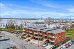 Beautiful updated 4 Br Duplex, Brick Condo W/ 3 Full Baths. Located in a Gated community on a Private Rd. Rear views of the river, promenade and Whitestone bridge. 1 parking space included. Spacious W/ 2 Balconies and patio. Approx. 2086 Sqft. Open Concept LR/DR. Master Bedroom with full bath and walk-in closet. Hdwd Flrs., Kit W/ Granite Counter Tops, Central AC & Heat. Energy Star Rated. Quiet Nbhd. Next to 6 Acre Waterfront Promenade. N/Hood Video Surveillance System & Security Patrol. Tax Abatement through 2029 Reduces the annual Taxes To $1, 826.56. Close To Buses, Schools, Shopping & MacNeil Park.