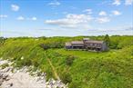 Enjoy year-round access to beautiful Isabella beach and walking/biking on the recreational path to the East End of the island. Sweeping estate includes guest cottage â€“ the two lots offer plenty of options! Nestled on a high bluff is approx. 4.7 private and lush acres of trees, lawns and perennial gardens with 665 feet of frontage on Block Island Sound with a path to a private beach and access to Isabella Beach. Breathtaking views from almost every room of this comfortable year-round island home and guest cottage designed by Mark Denton and built by HP Broom in 1998. The open concept interior is unique and spacious with rustic pine paneling, barn flooring and built-ins throughout, featuring a warm and inviting sun filled great room with exposed beams and trusses, stone fireplace, and glass doors. The low maintenance, and comfortable unfinished floors were designed to be easy to care for and practical- warm under foot in the fall and winter, cool in the summer. The main house boasts 5 bedrooms, 4 1/2 baths, eat-in kitchen, pantry, library, office, bonus room, wine cellar, and additional private nooks for quiet relaxation. The guest cottage has two floors plus a basement and an outdoor shower. The top floor features a great room with kitchen and sleeping banquettes that have hidden storage below. There is a full bath and wood stove on the middle floor. With 5283 total sq ft, this wonderful estate offers a generous amount of private and common living spaces.