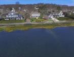 Waterfront Colonial Retreat â€“Discover timeless charm in this lovely historic colonial nestled along Bayvilleâ€™s serene waterfront. This bayside residence blends classic elegance with charming comfort. Features include an elegantly updated kitchen with modern appliances, ample counter space, formal dining room, and cozy light-filled living room with fireplace. Many rooms showcase breathtaking panoramic water views, providing a beautiful backdrop to enjoy daily. Step outside to the expansive wrap-around porchâ€”perfect for relaxing or entertaining while soaking in the natural tranquility. Upgrades include a 1600sq ft mother-daughter extension, (permit renewal required) with a separate kitchenette and 1.5 baths. A large private yard and separate patio make this the perfect home for entertaining. Spacious expanded interior, prime location, and a private oversized property make this a rare, desirable gem. Mooring rights with village approval/permit. Donâ€™t miss your chance to own this slice of paradise!  Elevated Property- flood free during Sandy.  Zillow estimated taxes are incorrect - Annual School and County: $14186