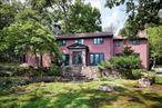 Traditional and very charming Brookwood is cedar sided, 4, 400 sq. ft. set high, and set back on nearly 5 beautiful acres. Panoramic mountain views, mature trees and plantings large and small. This naturally landscaped treasure surrounded by protected parklands even includes an adjacent stream and soothing gentle waterfall. Welcoming entry Foyer, Living Room light. bright and cozy with Wood Burning Fireplace. Large Library or Den, Formal Dining Room, open generous eat in Kitchen with built in banquette and custom cabinets. All rooms with high ceilings and authentic hardwood floors. Convenient half bath complete first level. There are two staircases main and back and two additional entries as well. Second level also with streaming light features the oversized Primary Bedroom and Primary Bath with two separate vanities, this suite includes a room size large open walk-in closet, additionally a bonus small room now used as meditation space. Four additional bedrooms and two full baths. Carport and gorgeous Courtyard from Kitchen to generous two car Garage. Attached to Garage is a storage area for sport equipment or garden tools. Delightful and always wished for a stand-alone heated studio room for the aspiring writer, painter or simply the getaway. Private and Historic Tuxedo Park is a 24/7 gate guarded community within an hour&rsquo;s drive to mid-town Manhattan. The village offers swimming, boating, biking, fishing and hiking at your doorstep.
