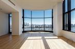 Ultra-Rare, Never-Lived-In 3-Bedroom with 14ft Ceilings & 2 Parking spaces.Offered for the first time ever, Residence 34A is a one-of-a-kind, ultra-luxury home perched high above Manhattan in the iconic 50 United Nations Plaza. This never-lived-in 3-bedroom, 3-bathroom corner residence features soaring 14-foot ceilings, panoramic skyline vistas, and direct, breathtaking views of the East River from every roomâ€”an exceptionally rare offering in one of Manhattanâ€™s most prestigious addresses.Wrapped in floor-to-ceiling glass, this luminous 2, 609 sq ft home is one of only two 3-bedroom units currently available in the buildingâ€”and the only one that has never been occupied. The dramatic ceiling heights, unique to only a handful of residences in the tower, elevate the already grand scale of the space and offer an unparalleled sense of volume and light.In addition to the three spacious bedrooms, the home includes a 4th flexible living space that can easily be used as a den, office, formal dining room, or media room to suit your lifestyle. In the listing photos, this area is virtually staged as a formal dining room to showcase its versatility.The enclosed kitchen is outfitted with pristine, never-used top-of-the-line appliances and sleek finishes, designed for both functionality and refined living. The adjacent living and dining areas flow seamlessly, creating an ideal space for entertaining or relaxing above the city.The primary suite is a serene retreat with East River views, a spa-like en-suite bathroom, and generous closet space. Two additional bedrooms offer flexible layouts for guests, family, or work-from-home arrangements.This residence is offered completely unfurnished and in pristine condition. Some images have been virtually staged to illustrate layout and scale.Two parking spaces are included in the saleâ€”an extraordinary value in NYC.Designed by world-renowned Foster + Partners, 50 United Nations Plaza is a full-service, white-glove condominium offering world-class amenities including 24-hour doorman and concierge, gated entrance, private motor court, fitness center, spa, and 75-foot swimming pool. Located just steps from the United Nations Headquarters, the building offers unmatched privacy, security, and sophistication for diplomats, executives, and discerning buyers.Shown by private appointment only.