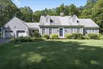 A spacious, posh, and elegant Smart Home loaded with high-tech upgrades - customized to the next level and perfectly designed for luxury living. Located about an hour from the city, 10 minutes from Metro North and major shopping centers, and less than 5 minutes from 84. The stately front entrance guarantees privacy and security with a beautiful custom metal entrance gate, a call box, and a 90-ft. long rock wall. The newly paved Belgium block-lined driveway is designed with Lutron wireless lighting, and the exterior perimeter has been integrated with security camera systems and an ADT security system. The lighting and the cameras are activated by remote and/or motion detection. Inside, this SMART home offers voice-controlled access by Alexa or your smartphone - from anywhere in the world - to operate the motorized window shades, door locks, interior lighting, security system, and the garage doors. All devices are on a dedicated Wi-Fi system. Can you imagine that this charming estate is beautifully surrounded by 5+ acres with abundant wildlife, mature landscaping, rock walls, lush lawns, and compelling mountain and trail views? Features include: underground utilities, a whole house propane generator, insulated Roth above ground oil tank, a slate and stone covered back porch, two remote controlled gas fireplaces (living room has an over-sized hearth), an air quality monitoring system that constantly checks radon, humidity, VFCs, and temperature levels, a newer well pump and pressure tank, and new triple Marvin sliding glass doors, creating a wall of natural light. The kitchen, powder room, mud room, and primary bathroom all have radiant heated floors. The kitchen has quartz countertops. a Maidstone SS farm-style sink, a breakfast bar, tiled quartz backsplash, SS GE Cafe appliances, and an abundance of maple cabinetry. The flooring is just beautiful with either wide plank pine, hardwood, or high-end ceramic. The 1st floor primary bedroom is purely sophisticated and massive with a beautiful gas fireplace, oversized windows, wall sconces, and recessed lighting; the en-suite has heated marble floors, dual Quartzite vanities, a 2-person six-foot walk-in tiled shower with seamless glass doors, jetted tub, heated towel rack, bidet, and a cedar walk-in closet. No expense was spared, no detail was overlooked, and no shortcut was taken to update the property completely. The elegant dining room and the music room, both with crystal chandeliers, the beamed great room, and the library/home office complete the 1st floor. Upstairs: 2 sizeable bedrooms, updated bathroom, cedar-lined dressing room, and a built-in wall cabinet unit that is actually a hidden door accessing the huge walk-in attic. The wine cellar is hidden behind a SMART-Locked bookcase that has been customized with a wine refrigerator, wine crate panels, a metal ceiling, and built-in wine racks. The laundry area shares space with the utility access, a finished entertainment room, and a workout area. The 2-car attached garage has an unfinished walk-up loft that is the entire size of the garage; this would make an epic home office, art studio, apartment, or home gym. The 32ft detached 2-car garage/barn has 10 ft ceilings, an oversized garage door with an automatic opener, an area for a greenhouse or extra storage, and a workshop. and seamless gutters on the roof.
