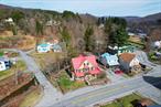 Take full advantage of this golden opportunity in the Sullivan County Catskills. Livingston Manor Main Street business district is thriving and bustling, having undergone a recent renaissance, and this mixed-use property offers endless potential. Listing includes two buildings on two separate parcels with ample off-street parking and frontage on Cattail Brook. The quaint and walkable river town, nestled along banks of the Little Beaverkill and Willoweemoc River, is a huge attraction to visitors and locals alike! Perfectly situated with maximum Main Street exposure it is well-suited for retail establishment, food-business, artist/ yoga studio, wellness center, live/ work set-up, bed and breakfast, family compound, rentals and more. Main building is rustic and charming with original woodwork and lots of windows to take in the natural light. It is currently used as a market/ cafe and features a large commercial kitchen as well as retail space on the main level and 8+ more rooms used for storage/ office space on the second and third. The second building, a 3-bedroom, 1.5-bath home, offers open plan living /dining, country kitchen, enclosed porch, beautiful wood floors and would be ideal for additional seating, events, or rental income. Main Street is rich with flourishing businesses including retail, specialty shops, breweries, professional services, restaurants and new developments including a sake distillery and a modern mixed-use building. Just two hours from NYC,  in a picturesque town drawing more attention each season, this is truly a rare chance to own one of the most flexible and iconic properties in downtown Livingston Manor.