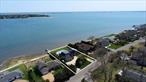Nestled along Tiana Bay, this exceptional waterfront property in Hampton Bays offers the ultimate summer retreat with breathtaking open water views. The home boasts a bayside heated gunite pool and a private dock, perfect for boating enthusiasts or anyone craving a luxurious outdoor lifestyle. The seamless blend of indoor-outdoor living is immediately apparent on the first floor, where an open-concept layout effortlessly connects the living, dining, and kitchen spaces to the expansive outdoor patio with panoramic water views as soon as you enter through the front door. The thoughtfully designed main level also features a spacious primary suite, offering both privacy and comfort with stunning water vistas and easy access to the pool area. Upstairs, guests will find three well-appointed bedrooms, including a junior primary suite and two additional rooms that share a Jack-and-Jill bathroomâ€”ideal for hosting friends and family in style. Large windows throughout flood the home with natural light, enhancing the airy coastal aesthetic. Complete with a two-car garage and situated just minutes from the heart of Hampton Bays, this home is a rare blend of elegance and ease. Whether you&rsquo;re entertaining by the pool, setting off from your dock for a day on the water, or simply enjoying the sunset from your deck, this waterfront gem promises an unforgettable summer escape.